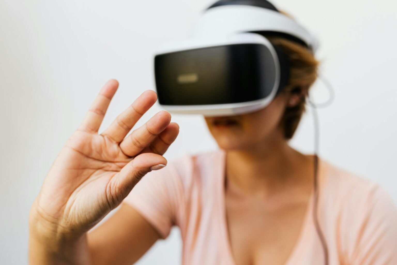 Meta Abandons Metaverse Investment to Focus on AI Hardware Development Person wearing VR headset representing Meta's metaverse technology pivot