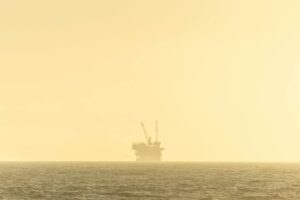 Industrial platform floating on calm ocean waters under blue sky