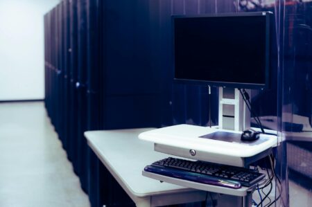 Google and OpenAI Partnership Threatens Amazon’s Cloud Computing Dominance Modern data center server room with rows of computing equipment and blue lighting