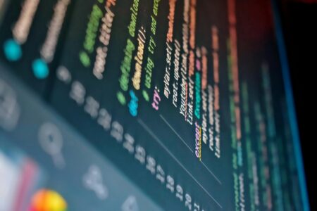 How AI-Powered Code Review Tools Are Replacing Senior Developers Developer working on code with multiple monitors displaying programming interfaces