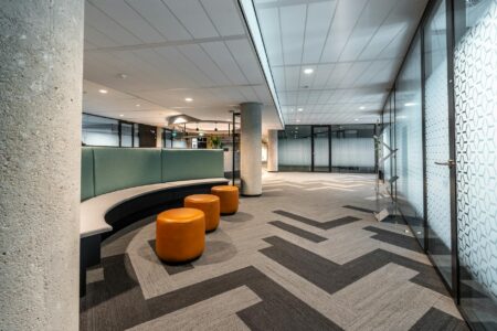 Modern bank lobby interior with traditional teller windows and customer service areas