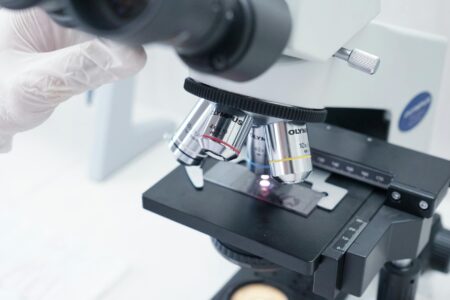 How Machine Learning Is Revolutionizing Protein Folding Research Modern laboratory microscope representing scientific research and protein structure analysis