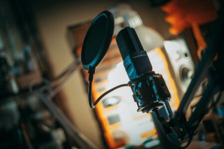 How AI-Generated Podcasts Are Competing with Human Hosts Professional podcast recording setup with microphone and audio equipment