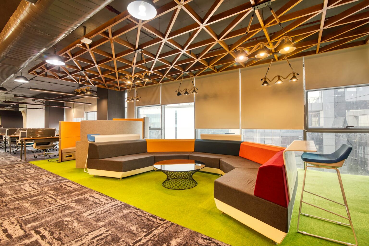 Modern open office space with contemporary furniture and natural lighting where sleep pods might be installed