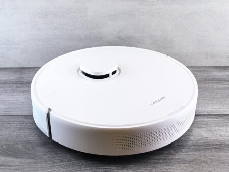 Modern robot vacuum cleaner on hardwood floor ready for cleaning