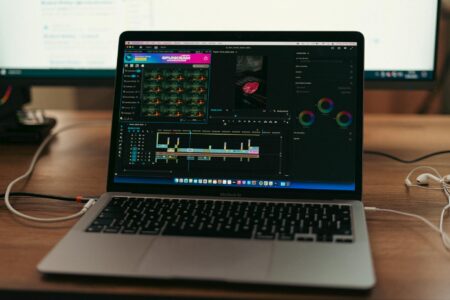 How AI Photo Editors Are Replacing Traditional Photoshop Skills Person using photo editing software on computer screen with colorful interface