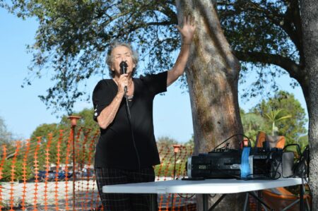 Woman speaking into microphone representing voice assistant interaction and speech recognition technology