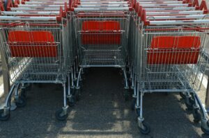 Modern shopping cart in grocery store produce section with digital display