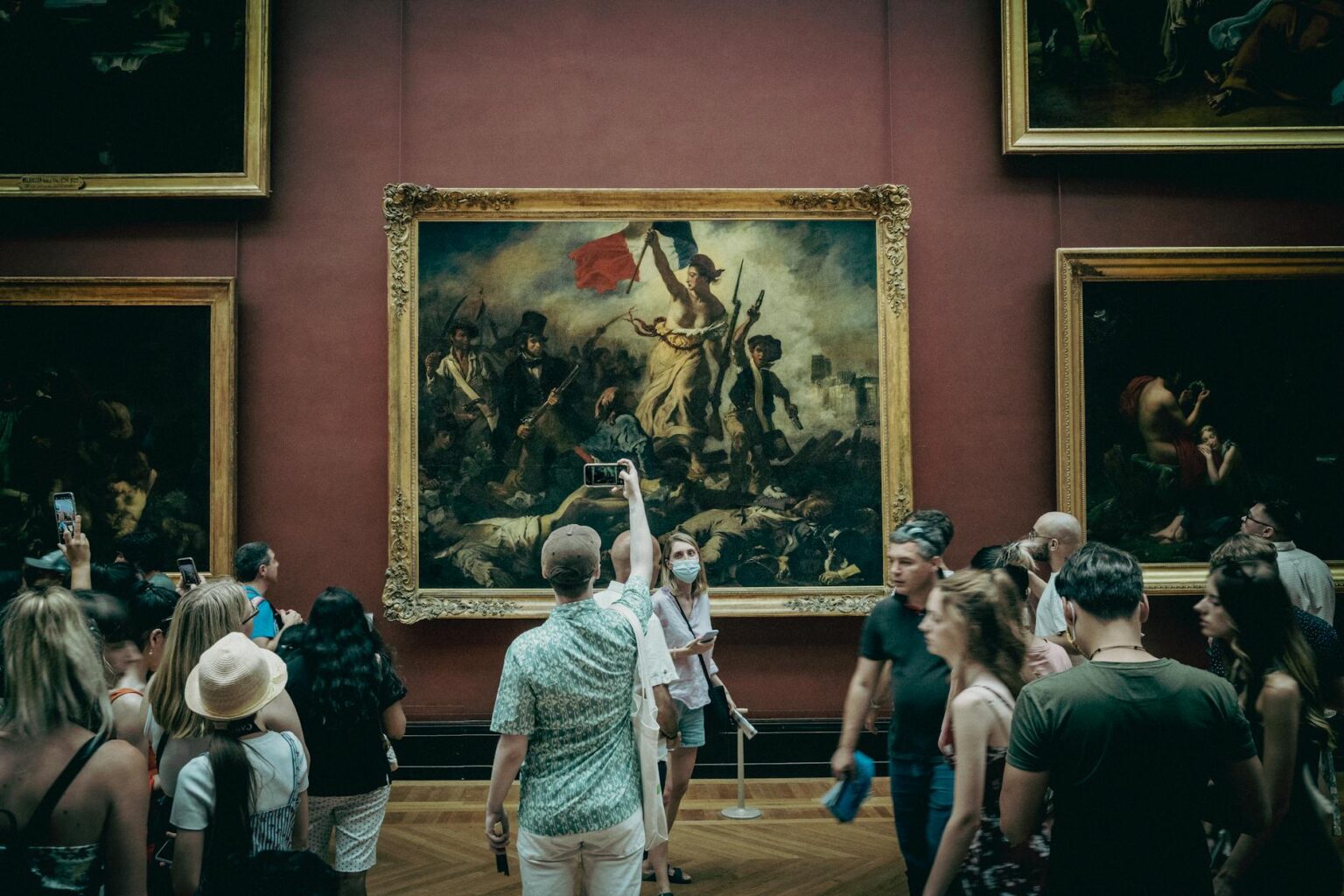 Why Major Museums Are Installing Augmented Reality Exhibition Guides Museum visitors using smartphones to view augmented reality content while examining exhibits