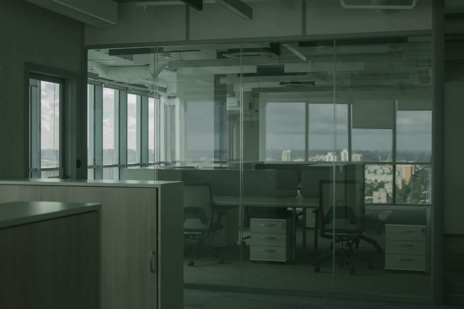 Contemporary office space with employees working at desks and in meeting areas