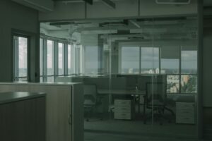 Why Major Corporations Are Ditching Remote Work for AI-Enhanced Offices Contemporary office space with employees working at desks and in meeting areas