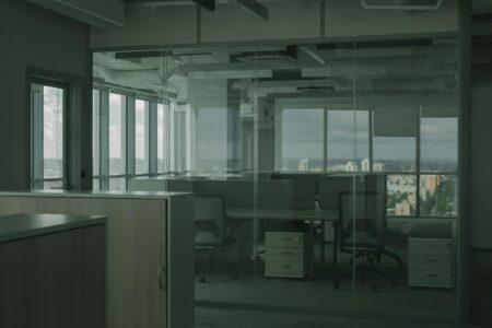 Contemporary office space with employees working at desks and in meeting areas