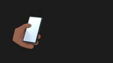 Person holding smartphone with various app subscription services displayed on screen