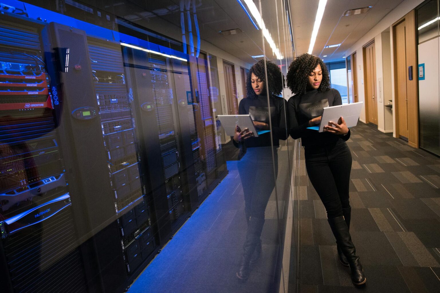 Modern data center server room with blue lighting showing cybersecurity infrastructure