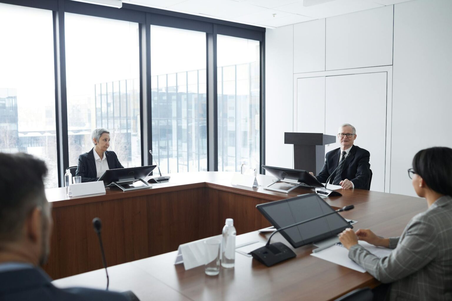 Corporate executives discussing technology strategy in modern conference room