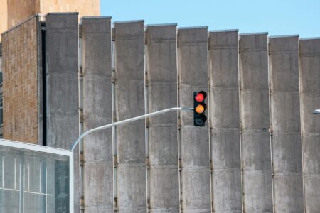 Modern traffic light system at urban intersection with sensor equipment