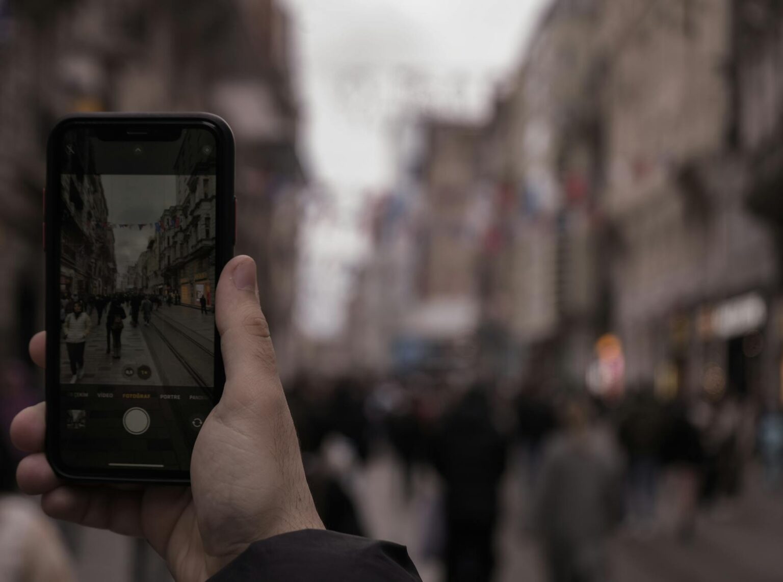 OnePlus 12 Pro vs Google Pixel 8: Camera Performance Showdown Person holding smartphone taking a photo, showcasing mobile camera capabilities