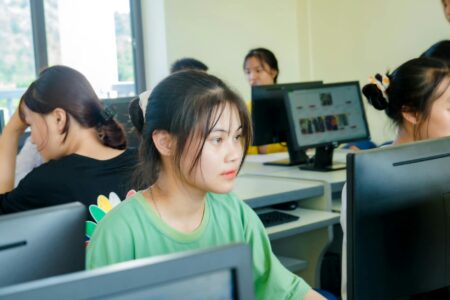 Major Universities Ban AI Writing Tools in Computer Science Programs Students working at computers in a university computer science classroom