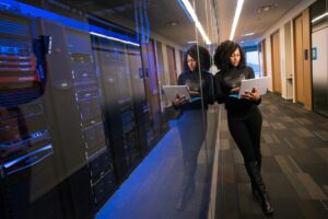 Modern server room with rows of computer equipment and blue lighting