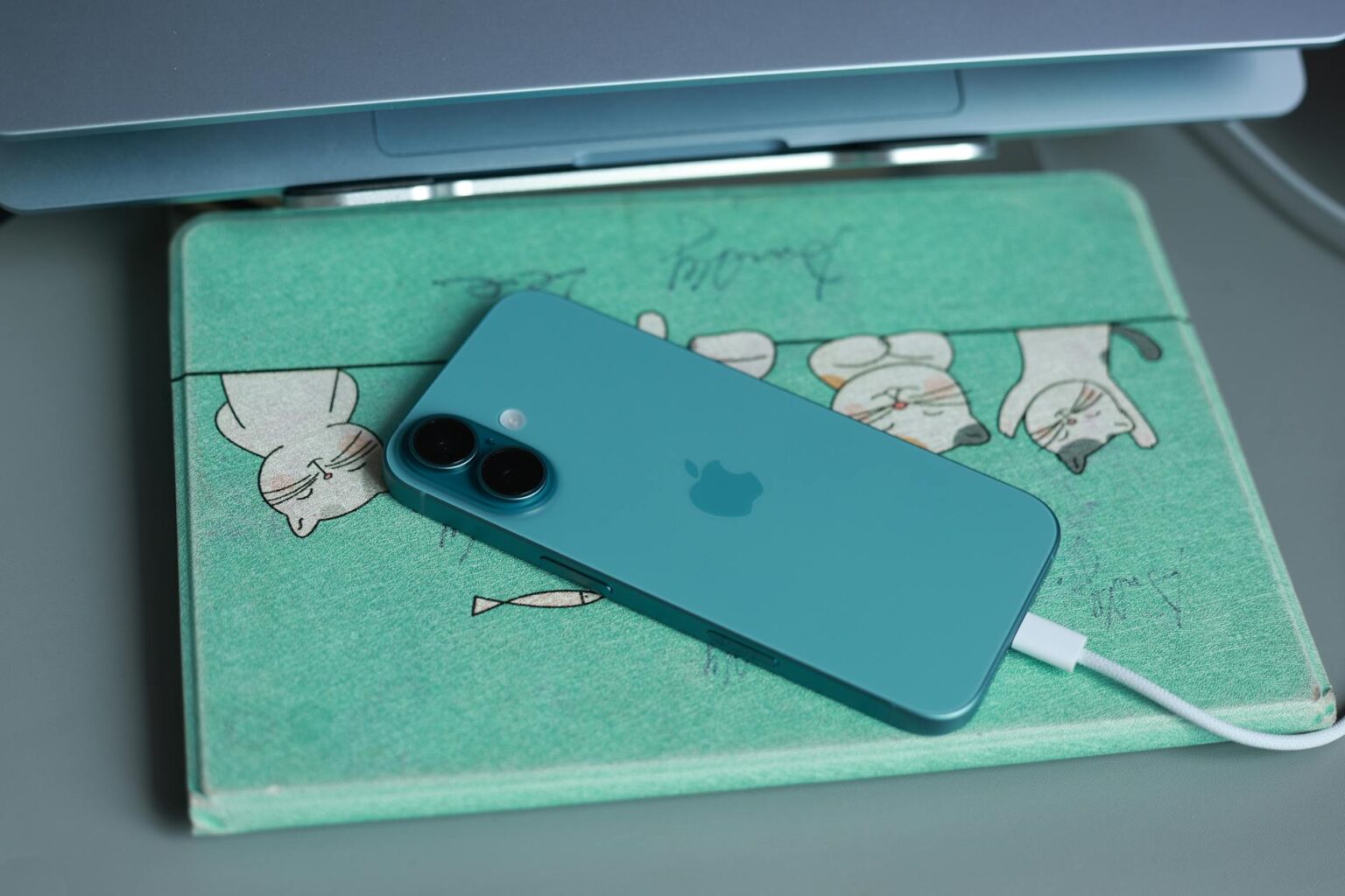 Why Wireless Charging Pads Are Finally Getting Multi-Device Zones Modern wireless charging pad on clean desk surface with multiple electronic devices nearby