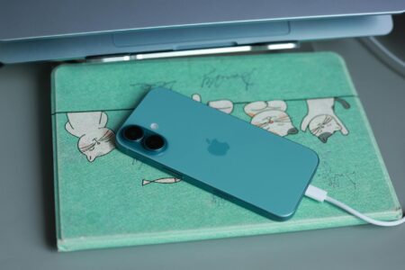 Why Wireless Charging Pads Are Finally Getting Multi-Device Zones Modern wireless charging pad on clean desk surface with multiple electronic devices nearby