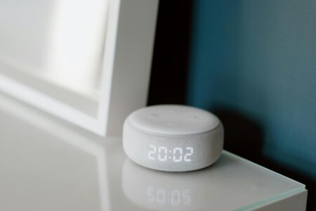 Smart Home Hubs Battle: Which Voice Assistant Ecosystem Wins Modern smart speaker device on kitchen counter with voice activation lights