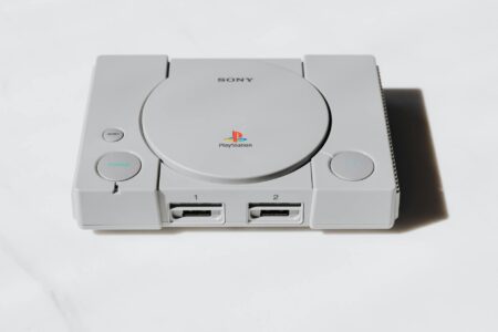 Modern handheld gaming device on desk with colorful screen display