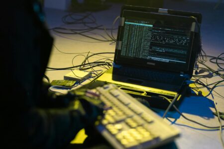 Google Catches First AI-Generated Zero-Day Attack in Wild Person working on computer with security code on screen