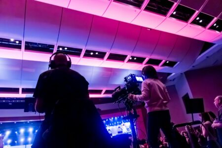New York Times Brings Wordle to Television Television game show studio with bright lights and host podium