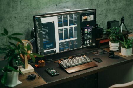 PowerToys Adds Monitor Controls to Windows System Tray Multiple computer monitors on a desk showing display management interface