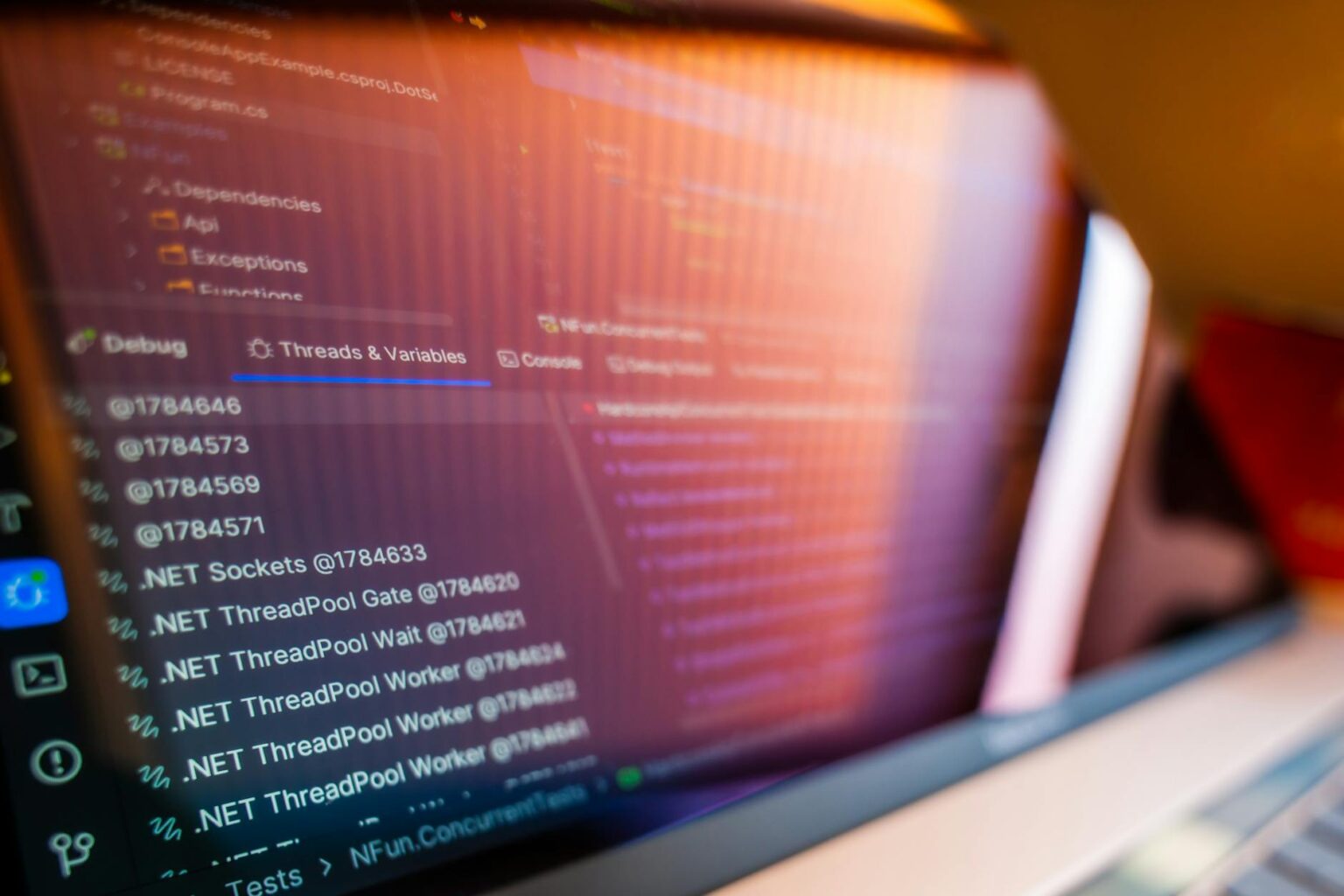 Developer working on code displayed on multiple computer monitors