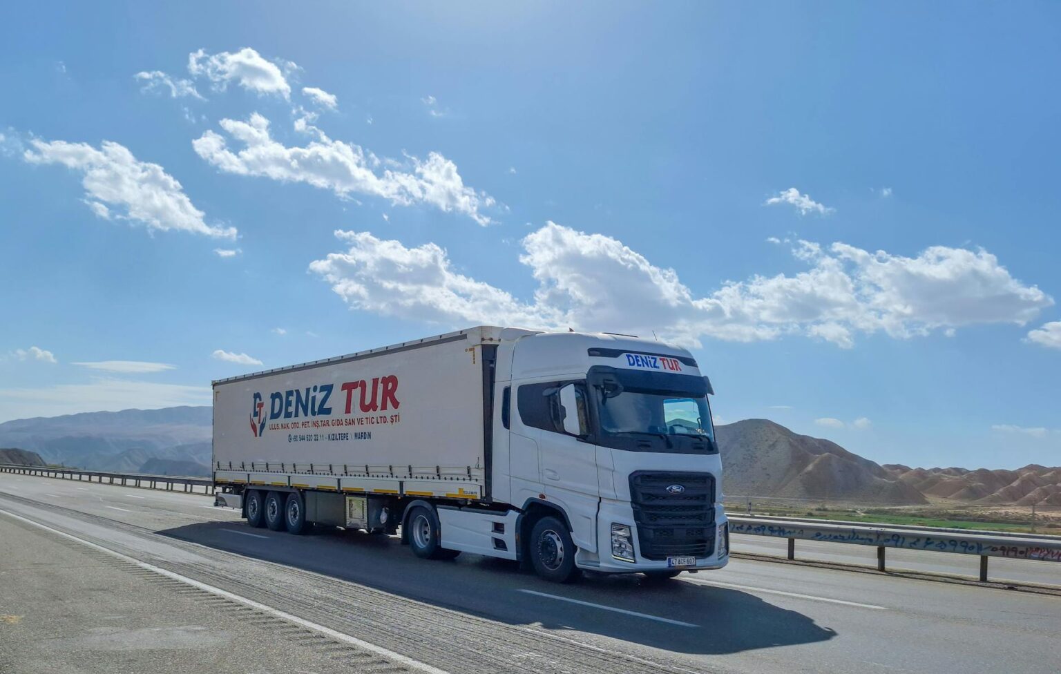 Fleet Giant Samsara Deploys AI to Map Road Deterioration Commercial delivery truck driving on city street with visible road surface