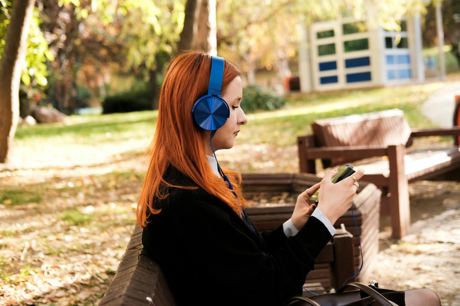 Spotify Expands Beyond Annual Wrapped with Complete Listening Archive Person using smartphone with headphones for music streaming