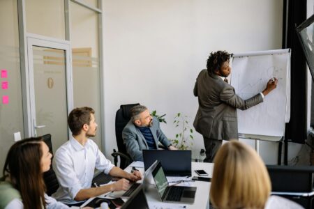Apple’s Latest Acquisition Further Confirms New Company Priority Business executives reviewing documents in modern conference room