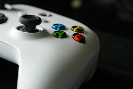 Sega Abandons Ambitious Super Game Initiative for Franchise Revivals Modern gaming controller on dark surface representing video game development