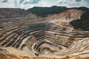 Open pit lithium mining operation with exposed rock and machinery