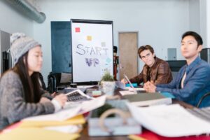 Investors in a conference room reviewing documents during a funding meeting