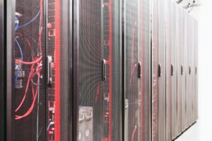 Rows of illuminated server racks inside a large data center facility
