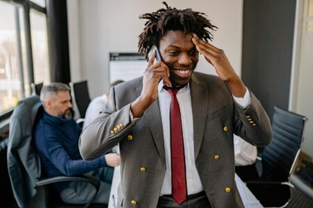 Thinking Machines Develops AI That Processes Input While Speaking Person having phone conversation in modern office setting