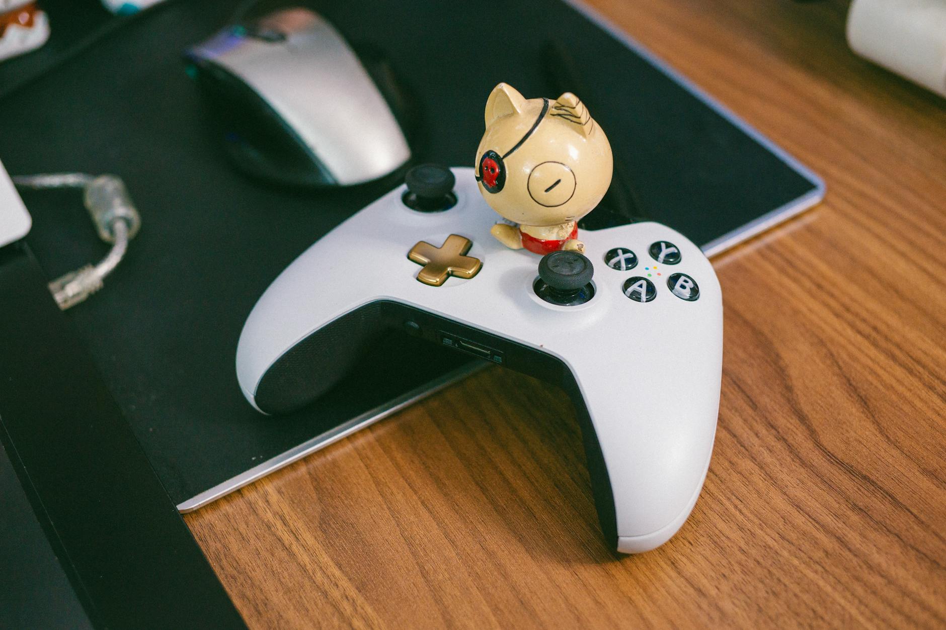 A gaming peripheral setup on a desk with controllers and accessories
