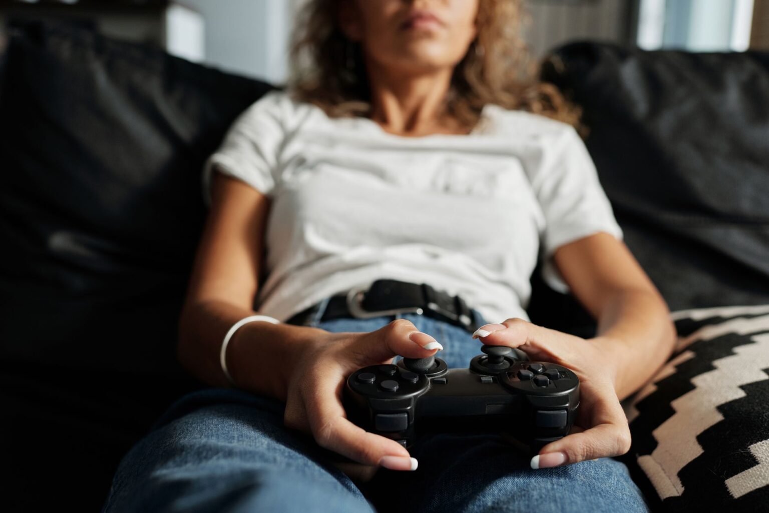 A gaming controller resting in dim atmospheric lighting suggesting a horror theme