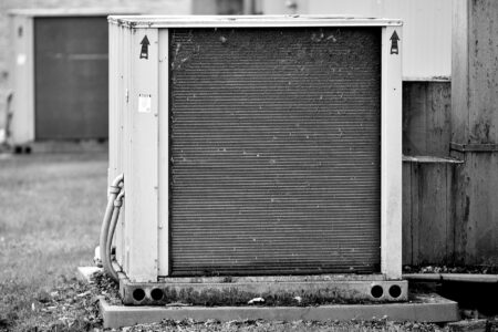 Exterior wall-mounted air conditioning unit on a residential building