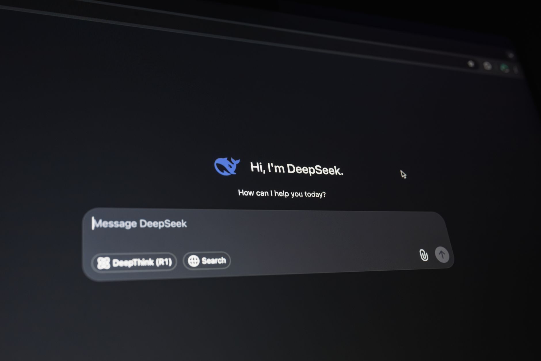 Person using an AI chat interface on a laptop representing shifting market share between ChatGPT, Gemini, and Claude