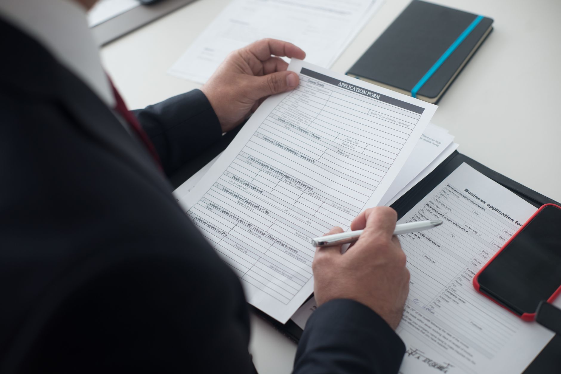 Startup founder reviewing application documents and planning strategy