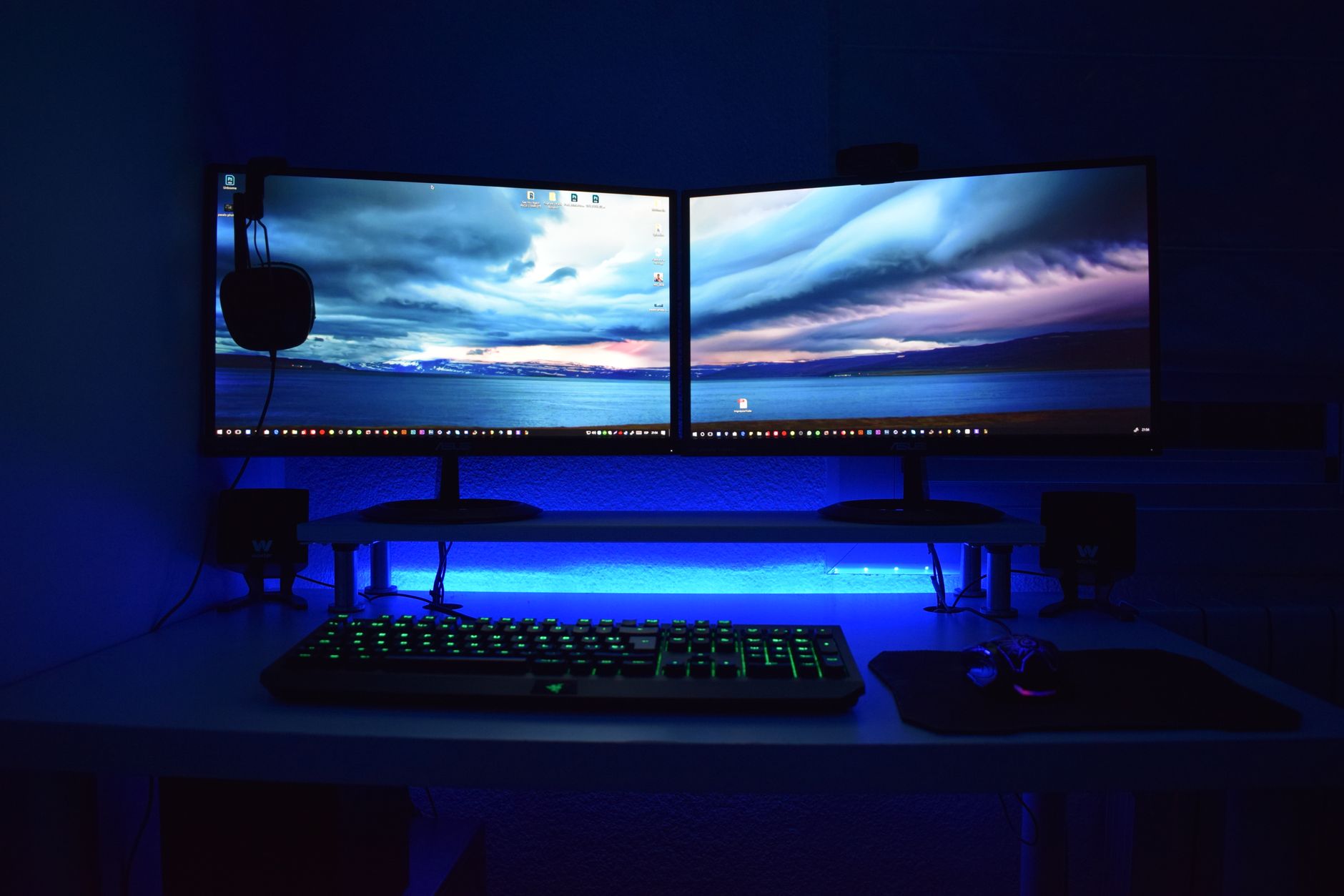 Monitor arm and desk accessories arranged on a sit-stand desk