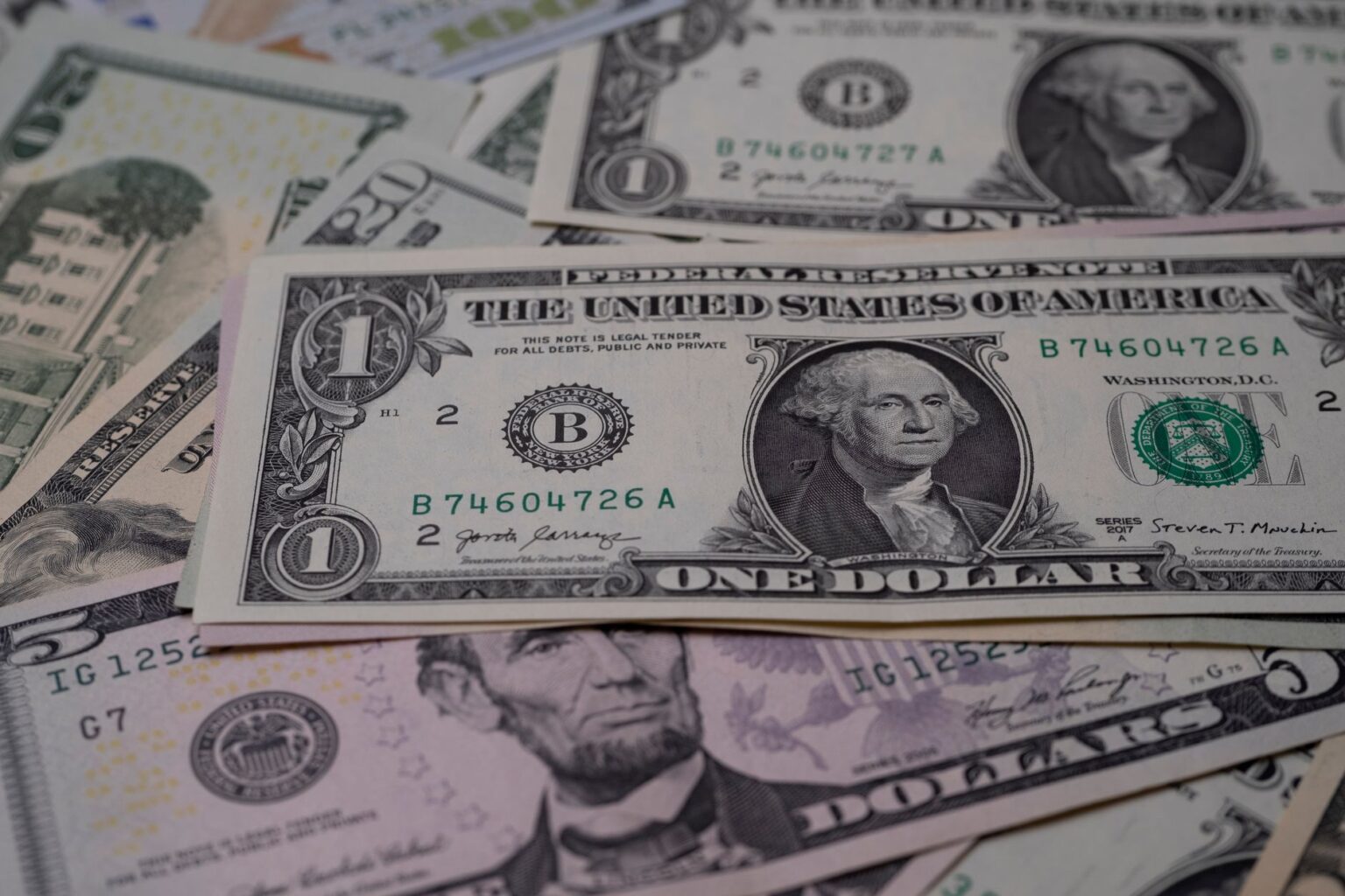Stack of US dollar bills representing government financial stakes and AI dividend proposals