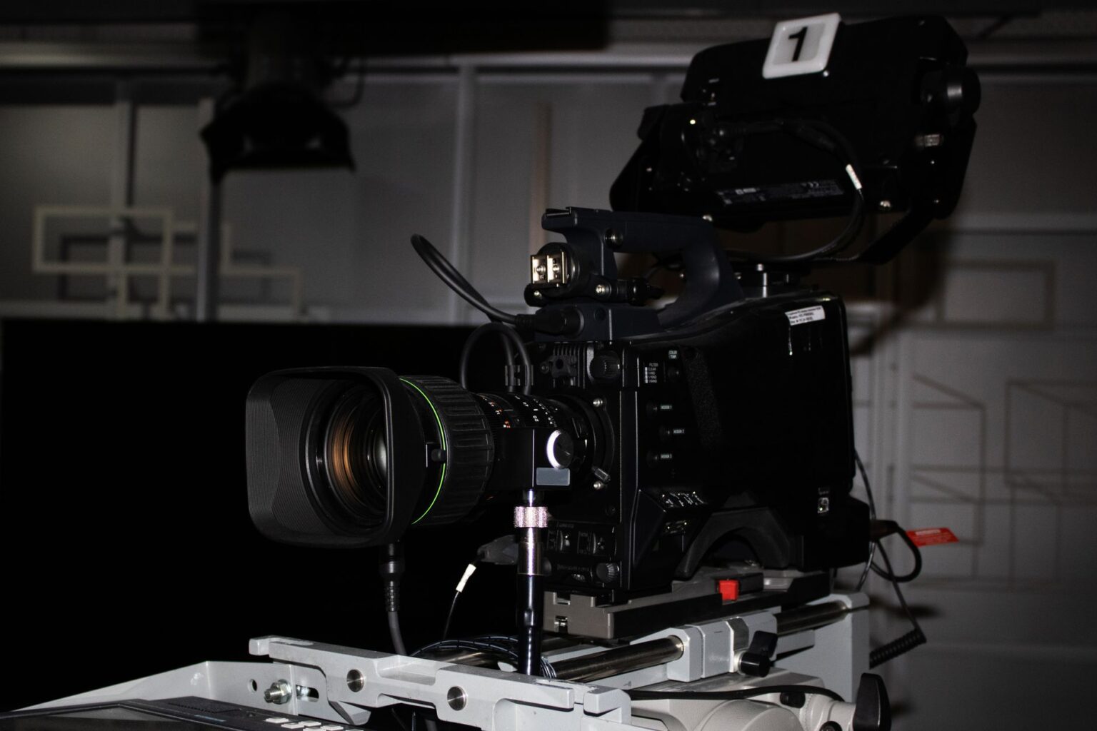 A broadcast television studio with production equipment and screens