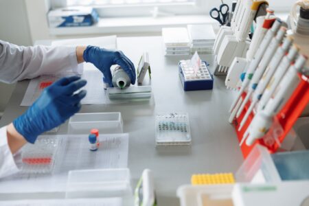 Researcher working in a modern biotech laboratory with scientific equipment