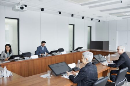 Business executives discussing regulatory policy in a formal boardroom setting