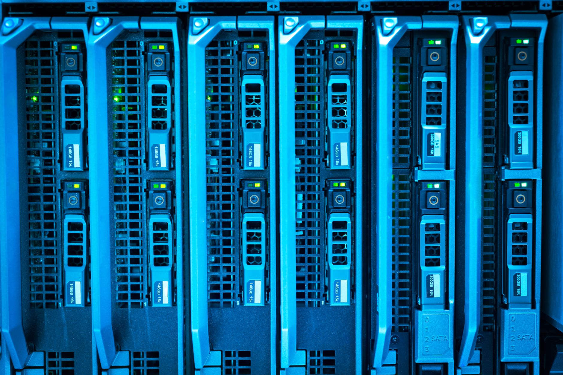 Illuminated server racks inside a dark data center representing critical infrastructure networks
